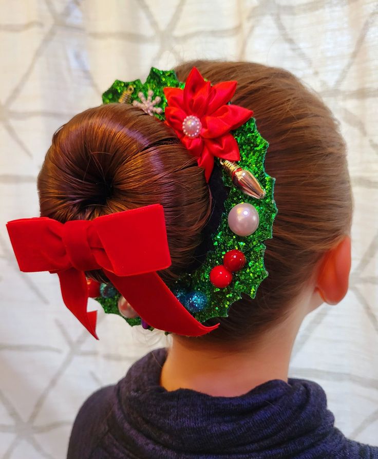 a-little-girl-with-bun-hairtyle-decorated-with-red-bow-and-green-ribbon-a-stunning-Christmas-hairstyles-for-kids