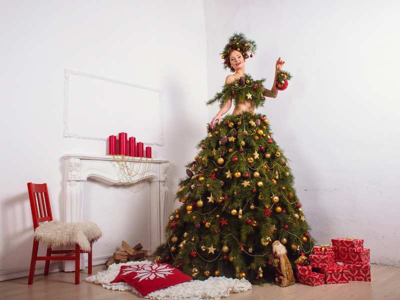 a- woman-dressed-like-a-Christmas-tree-with-grren-and-gold-ornaments-on-her-hair-it-is-one-of-the-best-Chrismas-hair-color-ideas