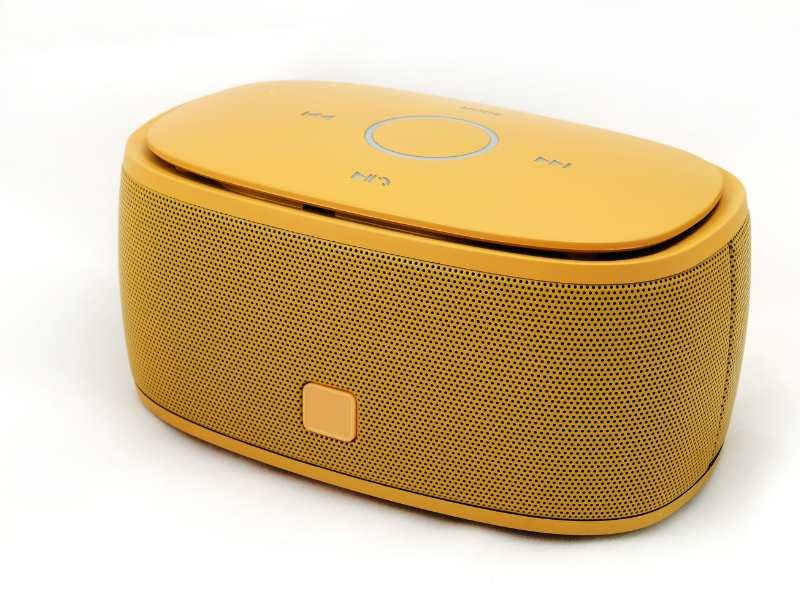 a-yellow-blue-tooth-speaker-on-a-white-surface