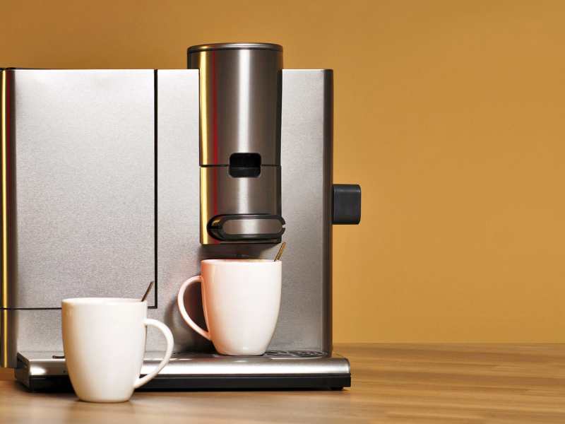 a-silver-coffee-machine-with-two-white-mugs