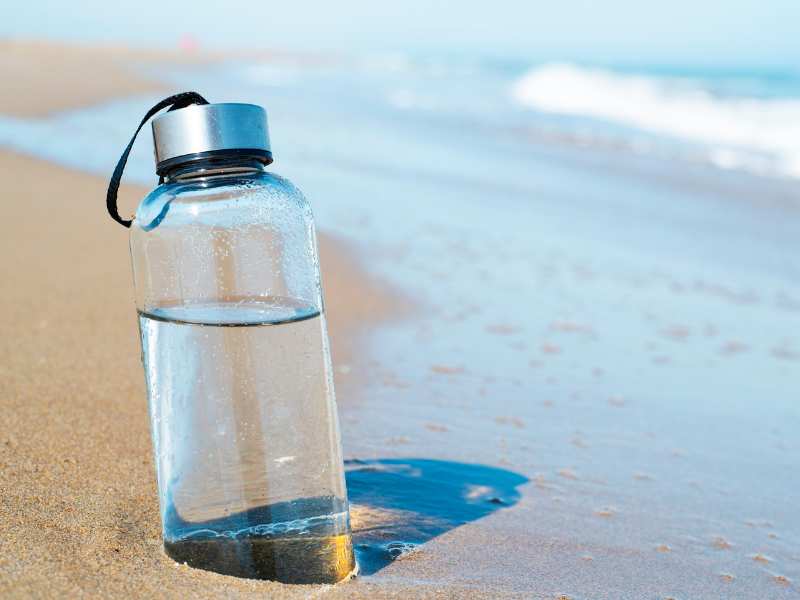 a-transparent-water-bottle-by-the-sea-side