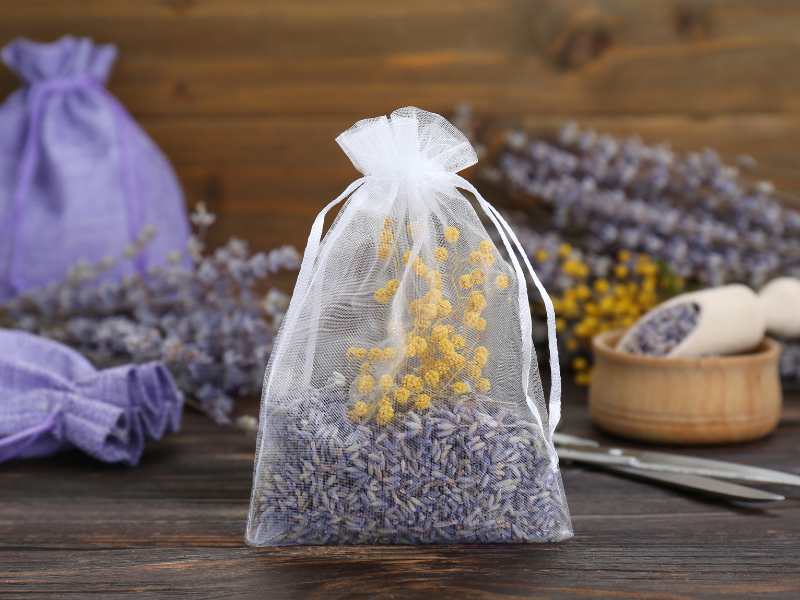 scented-sachet-with-dried-flowers-on-wooden-table