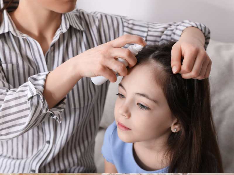 a-woman-spraying-a-little-girl's-hair