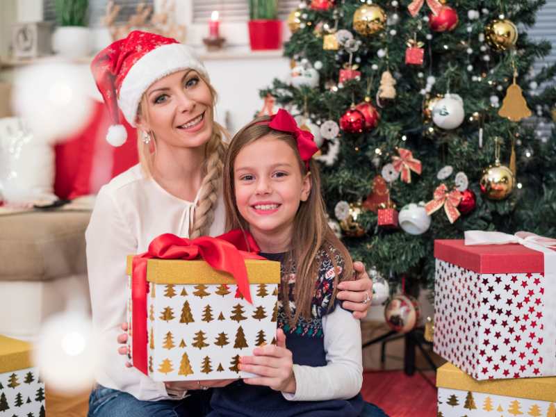 a-mother-and-her-daughter-with-a-box-of-gift-wrapped-for-her-mother-as-christmas-gift