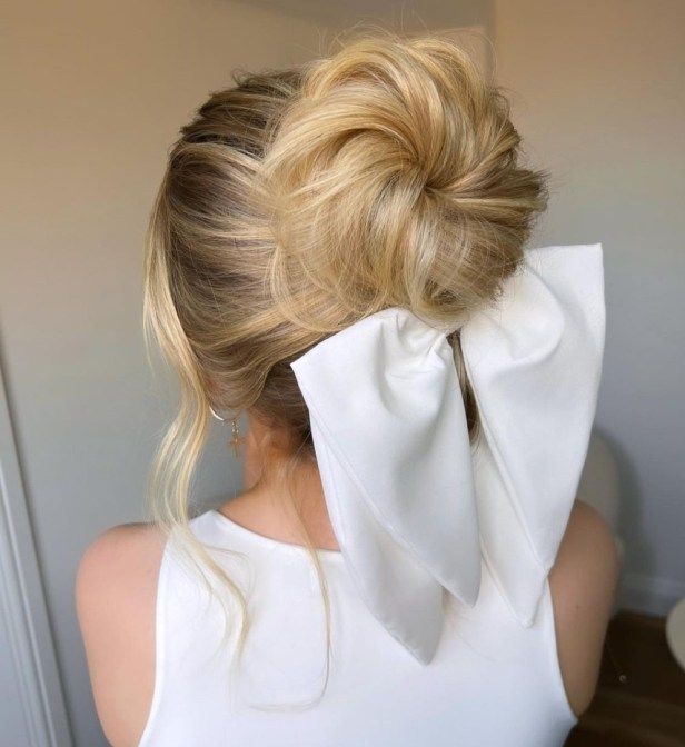 girl-with-white-festive-bow-on-low-bun-hairstyle