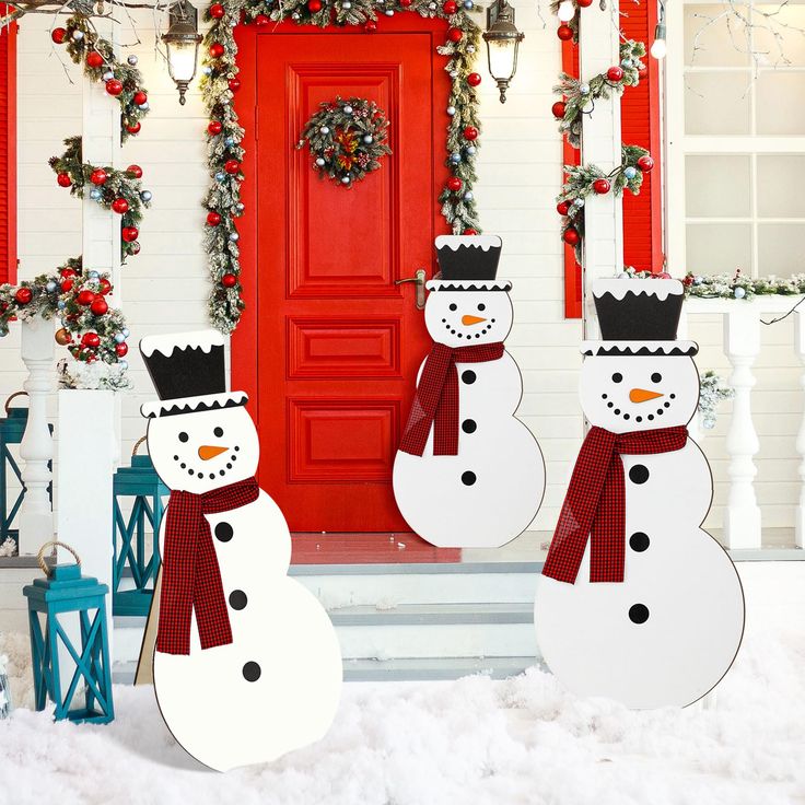 three-snowman-outdoor-by-a-red-door