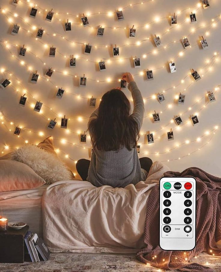 woman-fixing-Christmas-porch-decor-string-lights