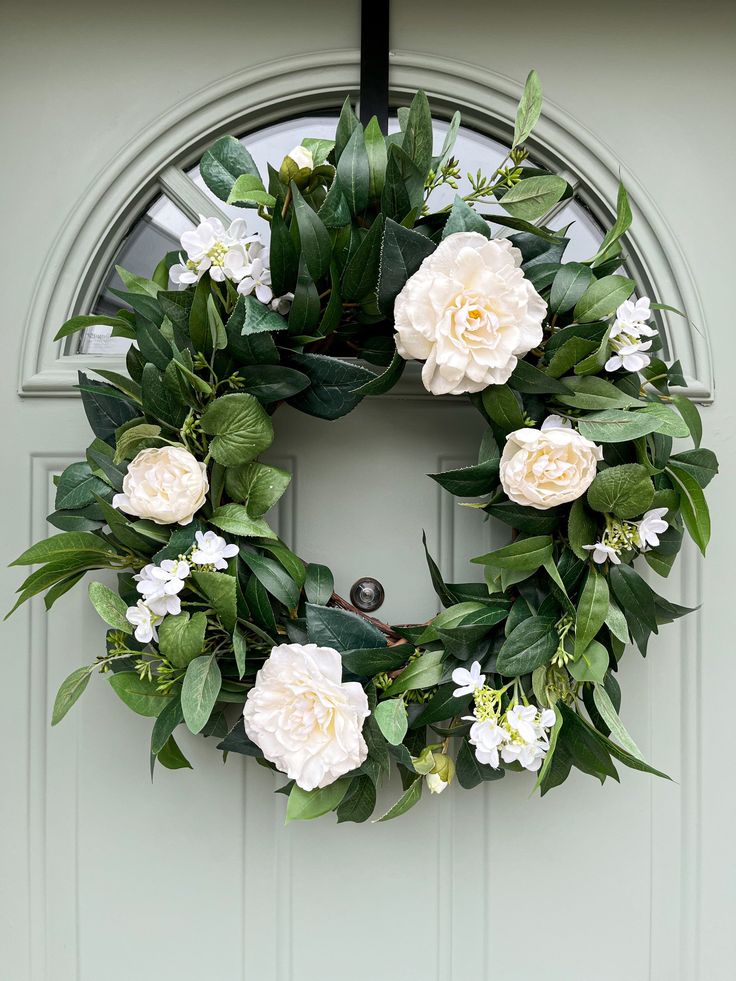 a-green-wreath-with-white-flowers