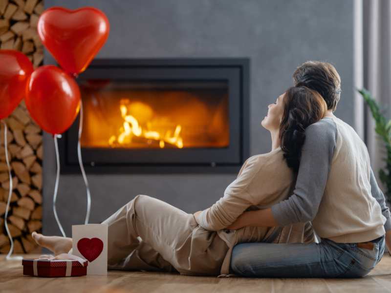 couple-on-a-valentine's-day-movie-marathon-with-red-heart-balloons