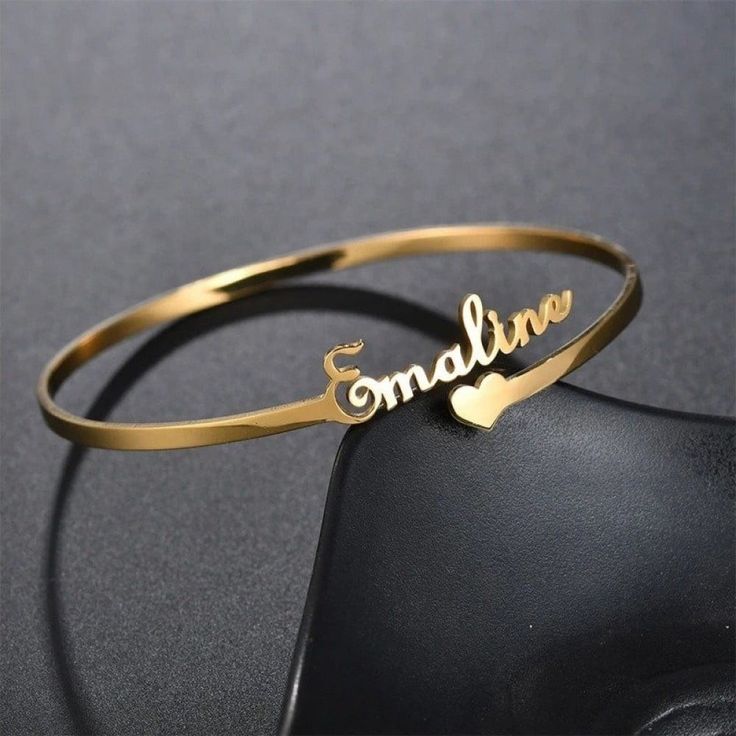 a-gold-color-bracelet-on-a-black-background