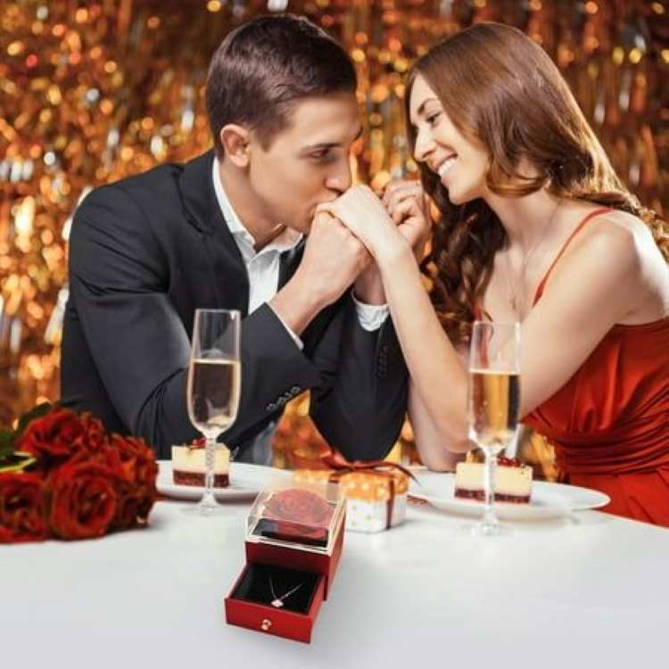 man-on-suit-with-lady-on-red-with-wine-on-the-table