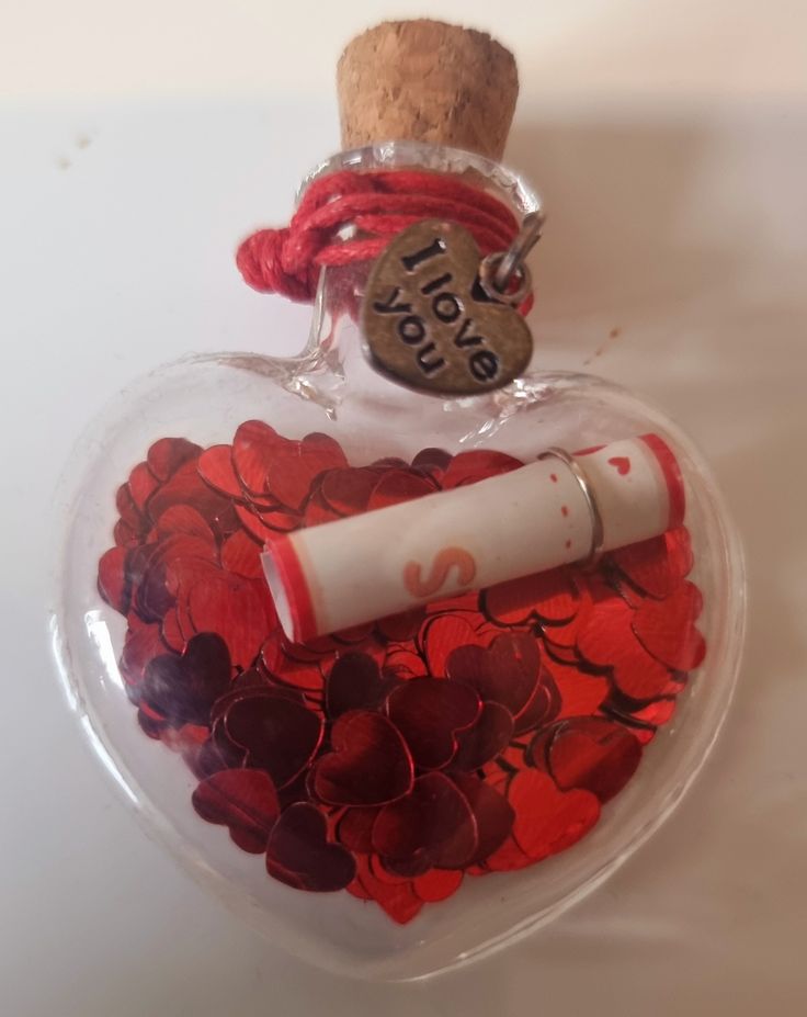 heart-shaped-bottle-with-red-flowers-and-a-note