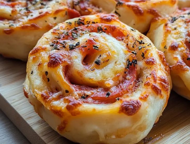 This-is-an-image-of-Cheesy-pizza-rolls-with-tomato-sauce-and-herbs-freshly-baked-to-golden-perfection