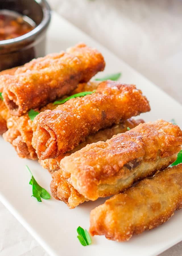 A-plate-of-golden-brown-crispy-fried-pork-and-mushroom-spring-rolls-garnished-with-fresh-herbs