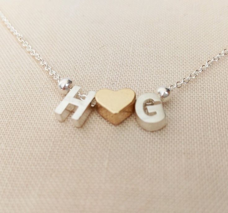 necklace-with-h-and-g-initial-on-a-brown-surface