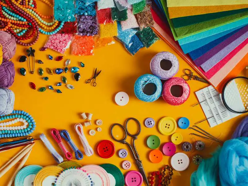 beads-buttons-scissors-andother-craft-items-on-a-yellow-background