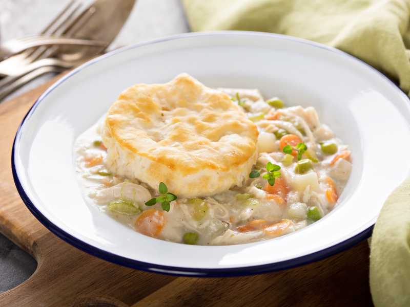 chicken-and-pie-garnish-with-vegetable-in-a-white-bowl-on-the-table