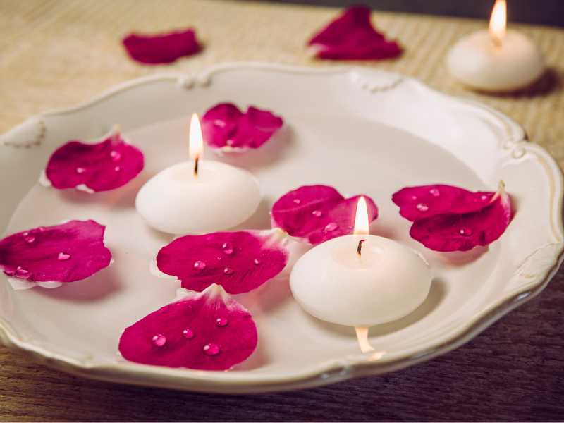 wine-petals-and-white-candles-in-water-in-a-bow