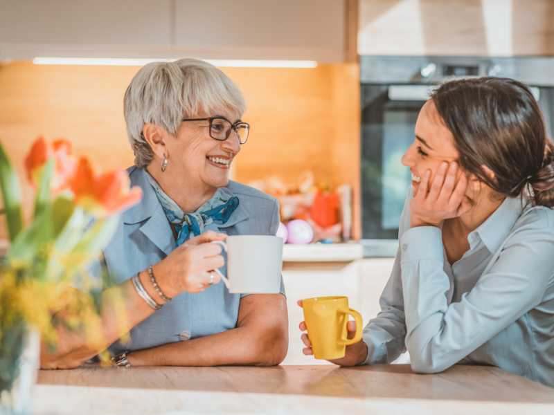 mother-and-daughter-discussing-with-a-cup-of-coffee