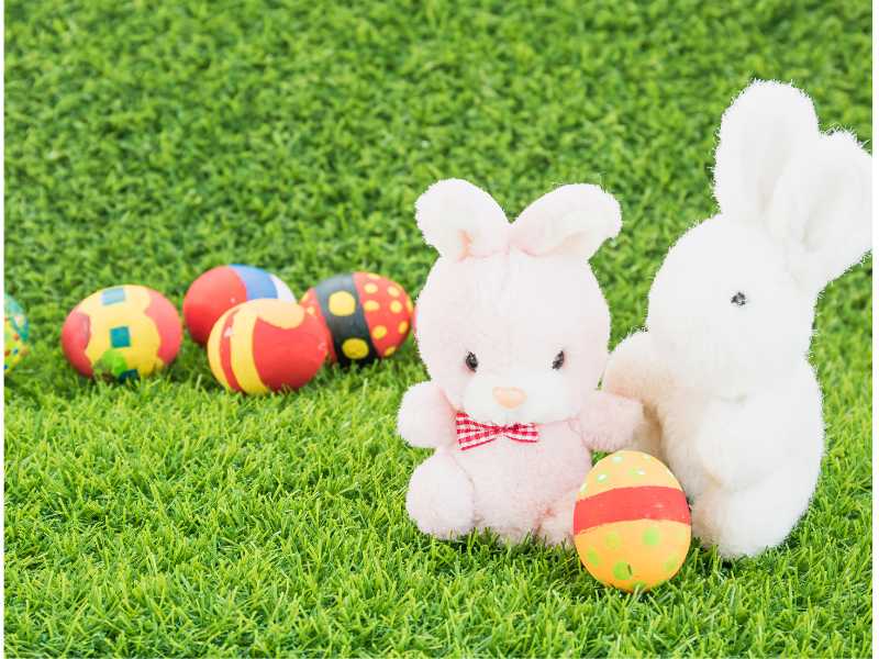 bunnies-with-easter-eggs-on-a-green-background