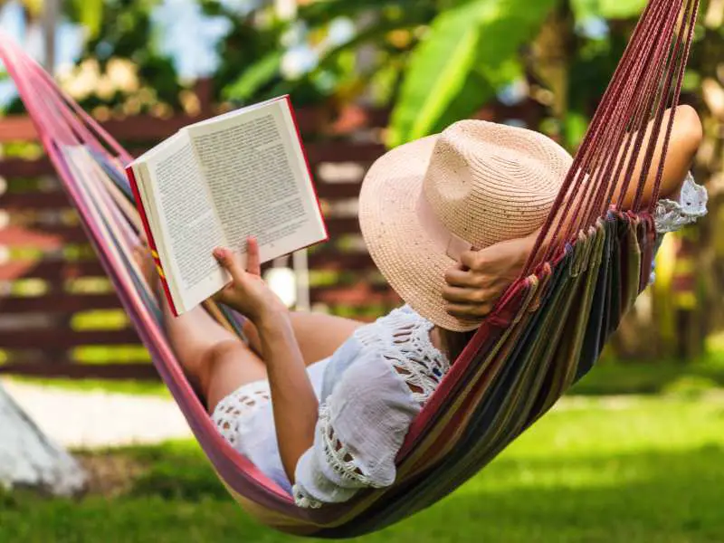 woman-reading-a-book-in-hammock-in-tropical-garden