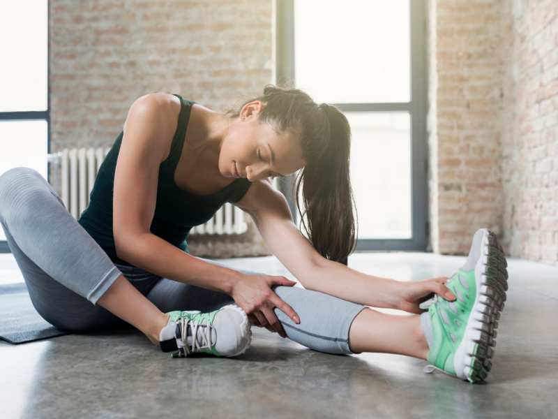 woman-sitting-on-an-exercise-mat-stretching