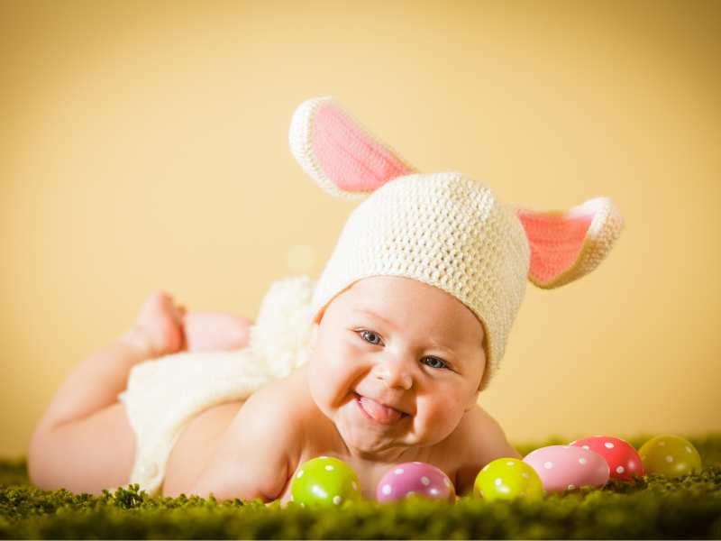 baby-with-bunny-hat-lying-on-easter-eggs-perfect-photoshoot-idea-for-baby's-first-easter-celebration