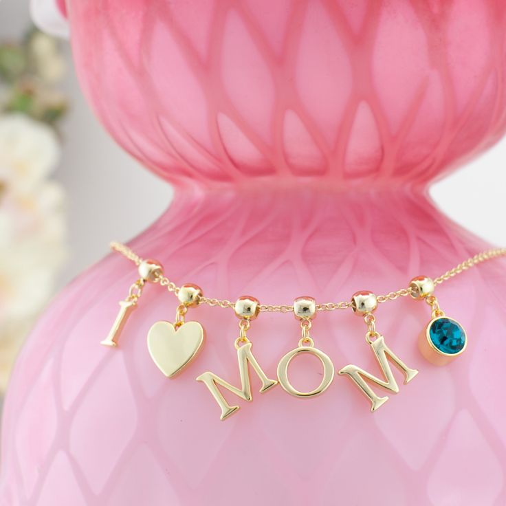 a-customized-i-love-you-mom-necklace-on-a-pink-jewelry-holder