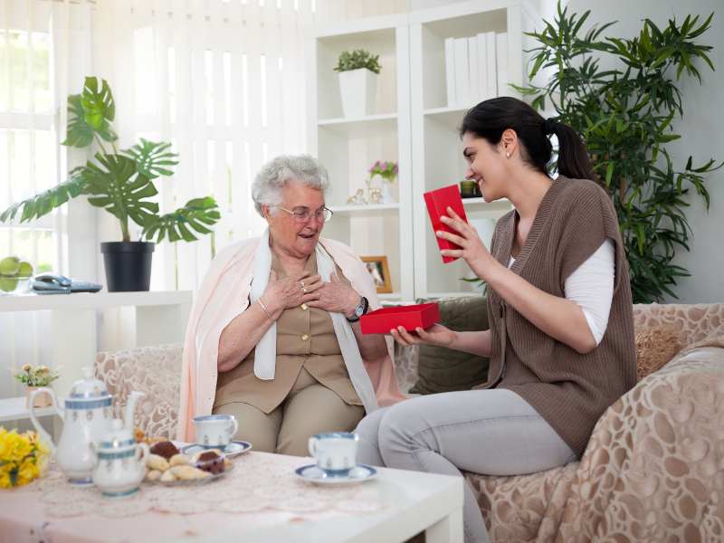 young-woman-presenting-mother's-day-gift-for-grandma