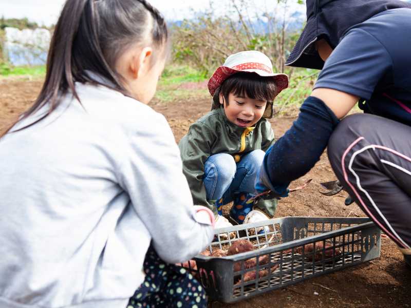 a-man-and-two-children-in-farm-experience-spring-break-ideas-for-family