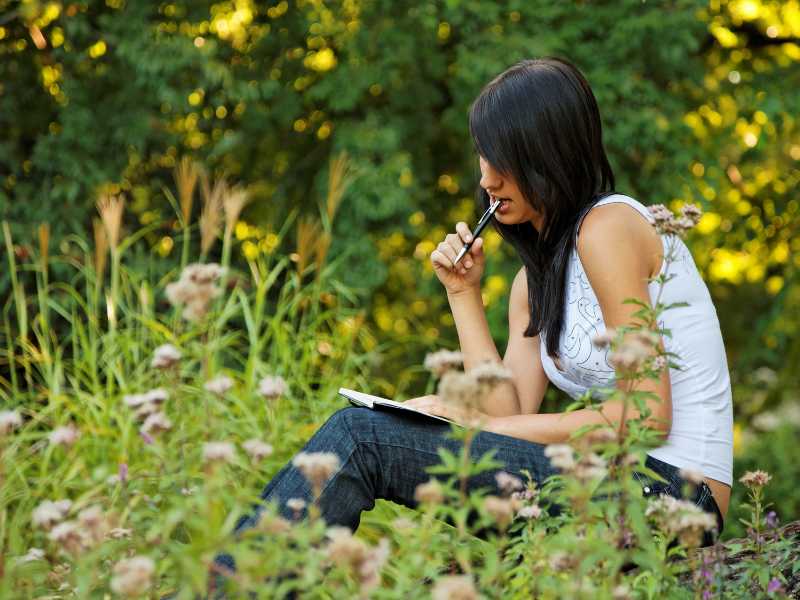 a-lady-in-a-garden-keeping-a-gardening-journal