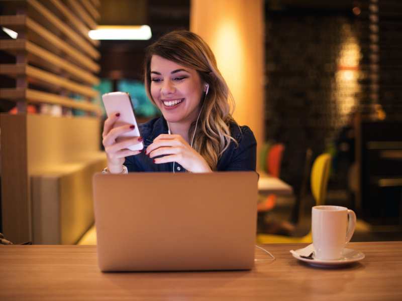 lady-with-a-phone-and-computer-in-a-yellowish-black-background