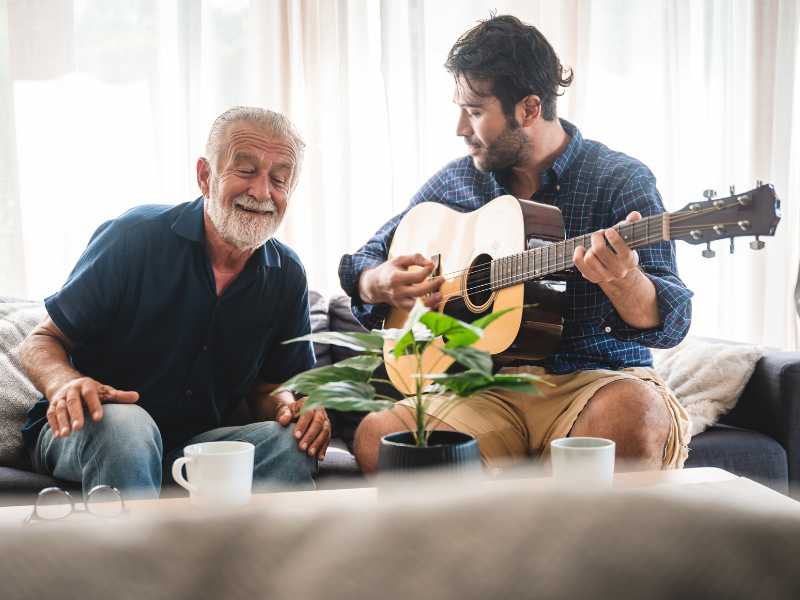 man-playin-getter-for-an-old-over-a-cup-of-tea-summer-tea-party