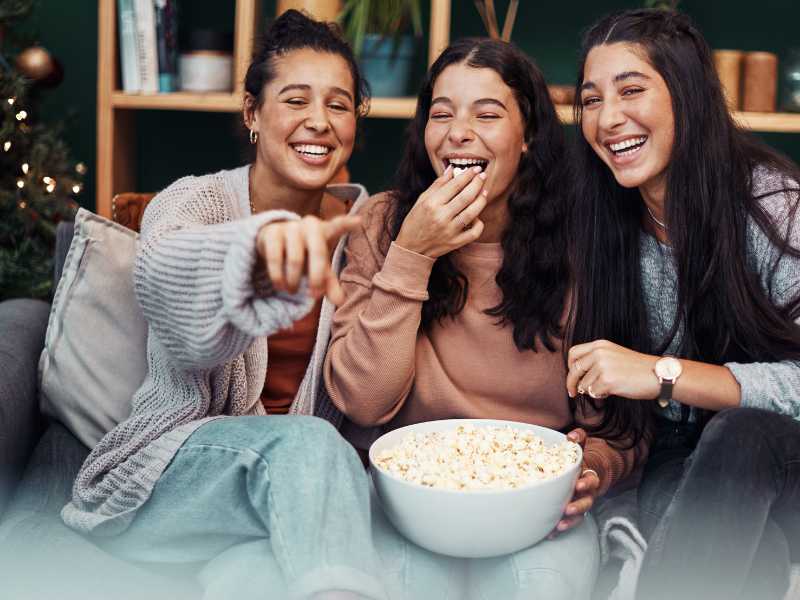 ladies-watching-movie-and-eating-popcorn-spring-break-ideas-for-family