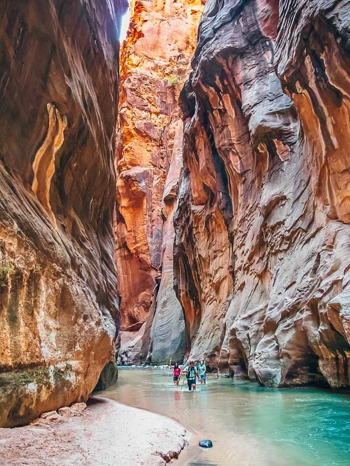 family-visit-national-park-with-rock-and-stream