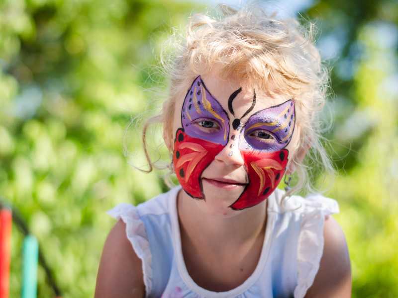 red-and-purple-butterfly-in-face-of a girl-4th-of-july-face-painting-ideas
