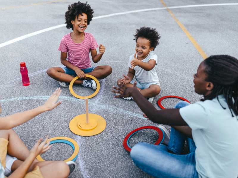 an-adult-and-children-playing-ring-toss-in-spring-parties