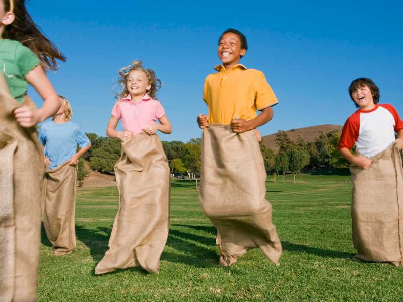 children-running-in-sack-race-for-spring-party