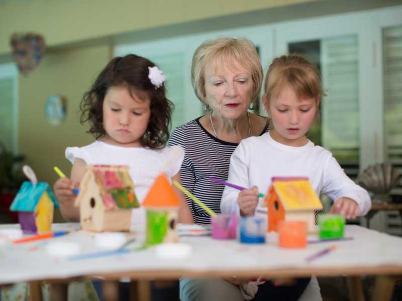 kids-standing-front-of-there-grandma-making-a-bird-house-in-spring-bucket-ideas-for-family