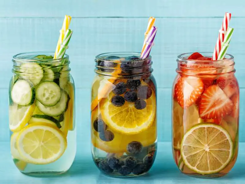 three-jar-of-tea-infused-cocktail-with-verities-of-fruit-summer-tea-party