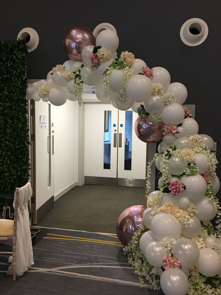 white-balloons-archway-entrance-on-a-dark-background