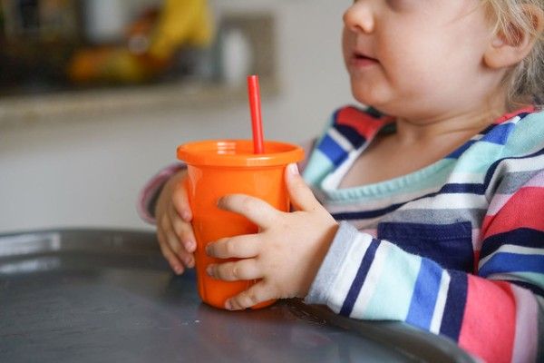 toddler-holding-water-to-potty-train-your-toddler-fast