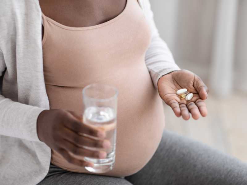 mom-taking-prenatal-vitamins-pregnancy-checklist-by-trimester