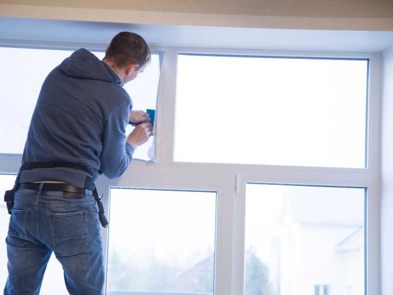 a-man-installing-window-reflector