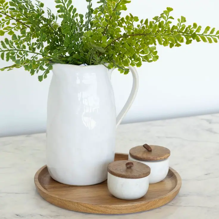 white-ceramic-pitchers-filled-with-greenery
